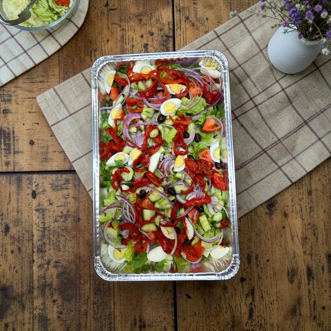 Large catering tray of garden salad with vegetables and egg