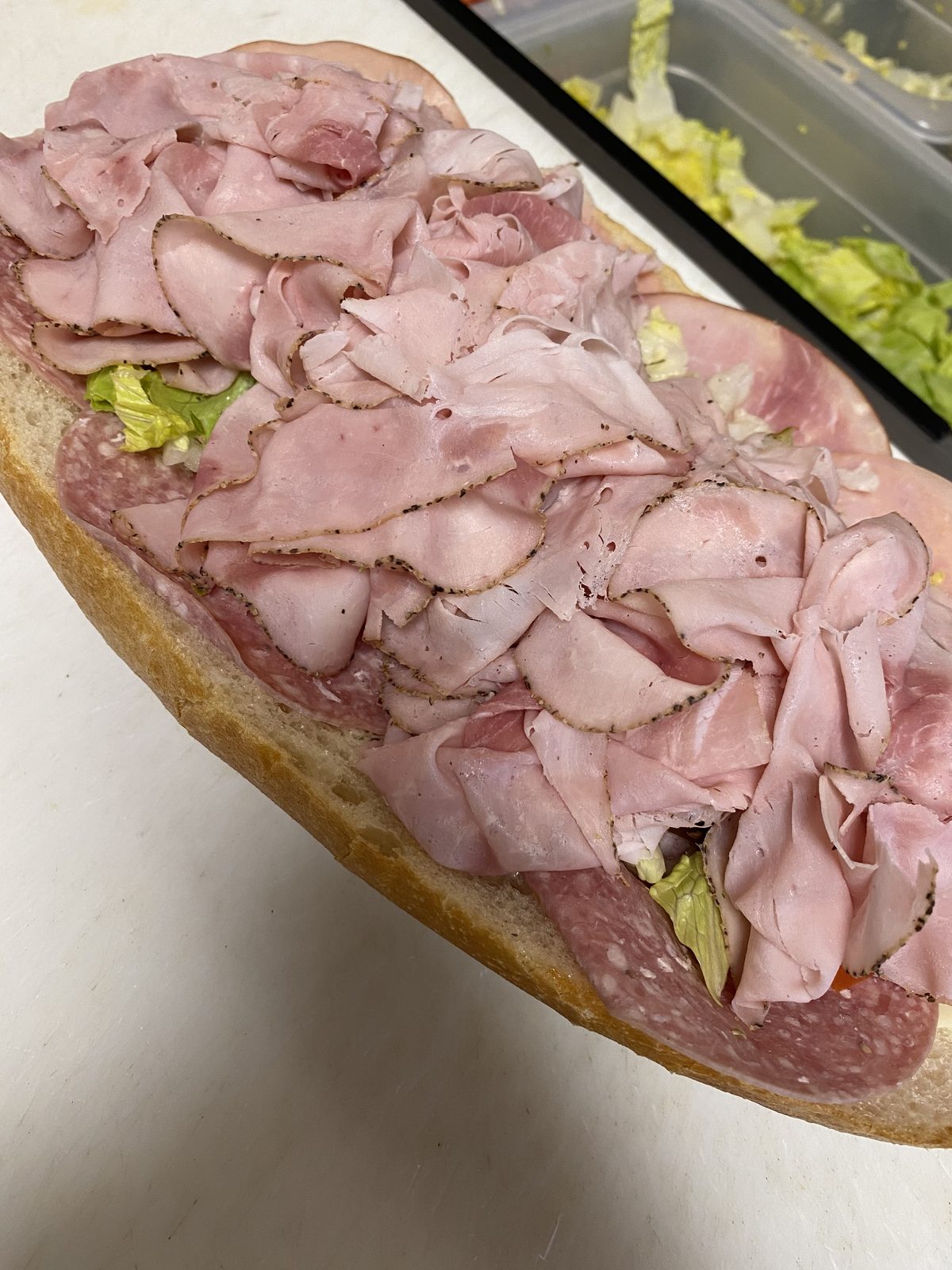 Italian hoagies loaded with deli meats, lettuce, and tomato