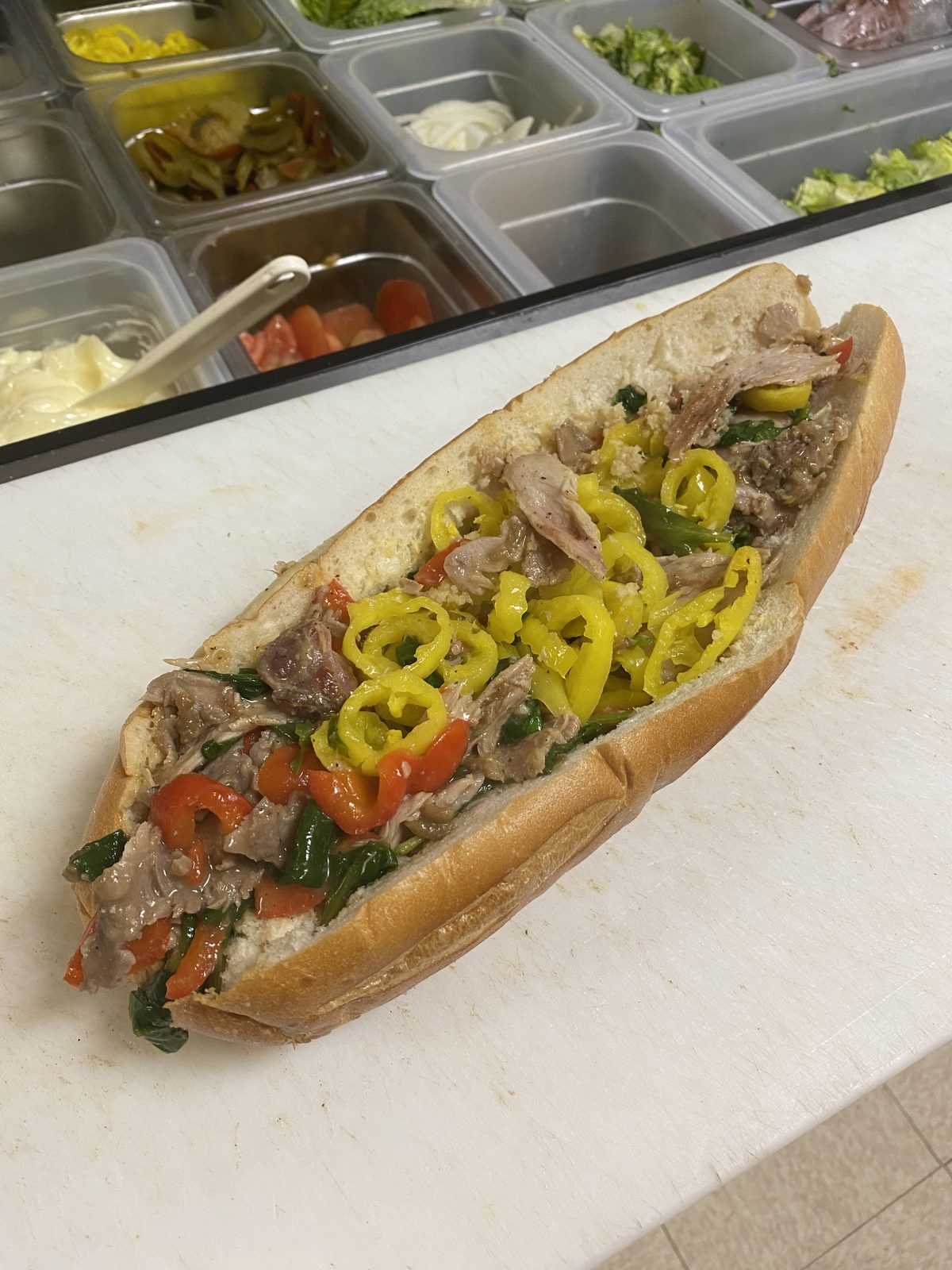 Italian roast pork sub with broccoli rabe, roasted peppers, and banana peppers