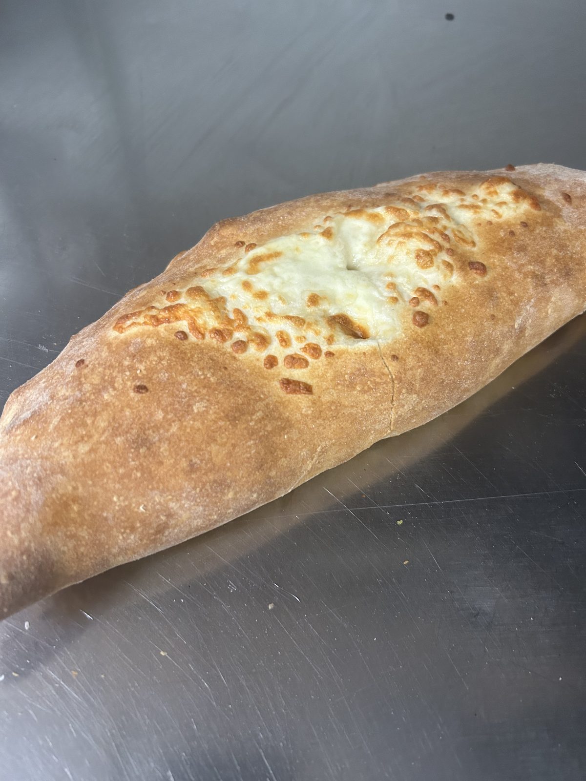 Golden baked stromboli stuffed with cheese