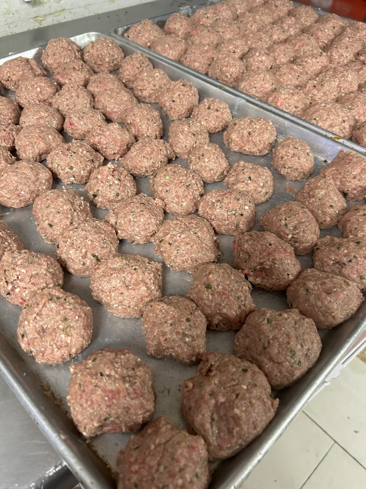 Hand-rolled meatballs in trays